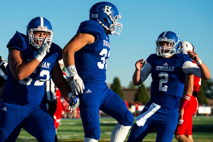(Chris Detrick  |  The Salt Lake Tribune)  Bingham's Amanaki Angilau (52) Bingham's Amoni Kaili (32) and Bingham's Ryan Wood (2) celebrate a touchdown during the game at Bingham High School Friday, August 25, 2017. Bingham is winning the game 24-17 at halftime. 