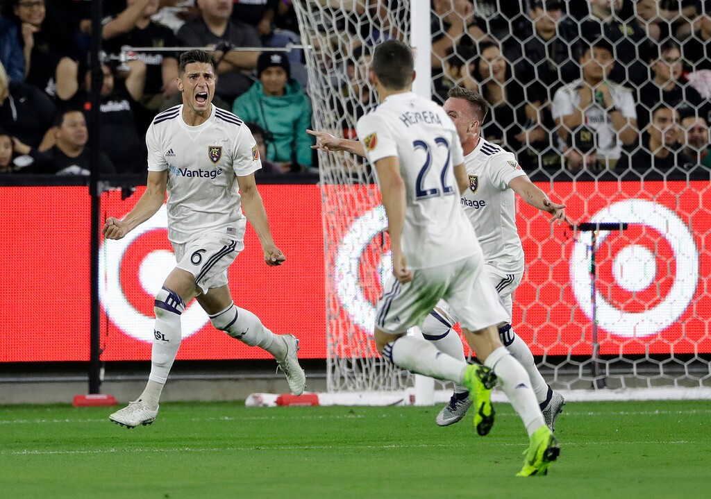 Real Salt Lake's Damir Kreilach, left, celebrates after scoring against Los Angeles FC during the first half of an MLS soccer playoff match Thursday, Nov. 1, 2018, in Los Angeles. (AP Photo/Marcio Jose Sanchez)