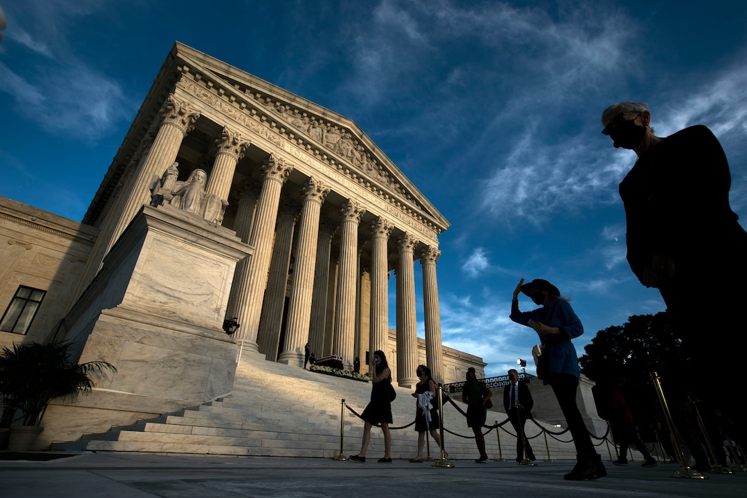 Mourners pay their respects as Justice Ruth Bader Ginsburg lies in repose under the Portico at the top of the front steps of the U.S. Supreme Court building on Wednesday, Sept. 23, 2020, in Washington. Ginsburg, 87, died of cancer on Sept. 18. (AP Photo/Jose Luis Magana)