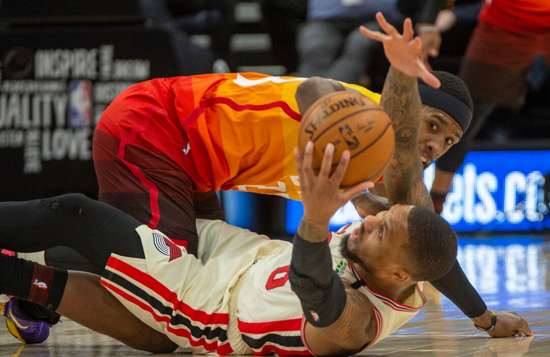 (Rick Egan  |  The Salt Lake Tribune)     Portland Trail Blazers guard Damian Lillard (0) goes for a lose ball along with Utah Jazz forward Royce O'Neale (23), in NBA action between the Utah Jazz and thePortland Trail Blazers in Salt Lake City, Friday, Feb. 7, 2020.