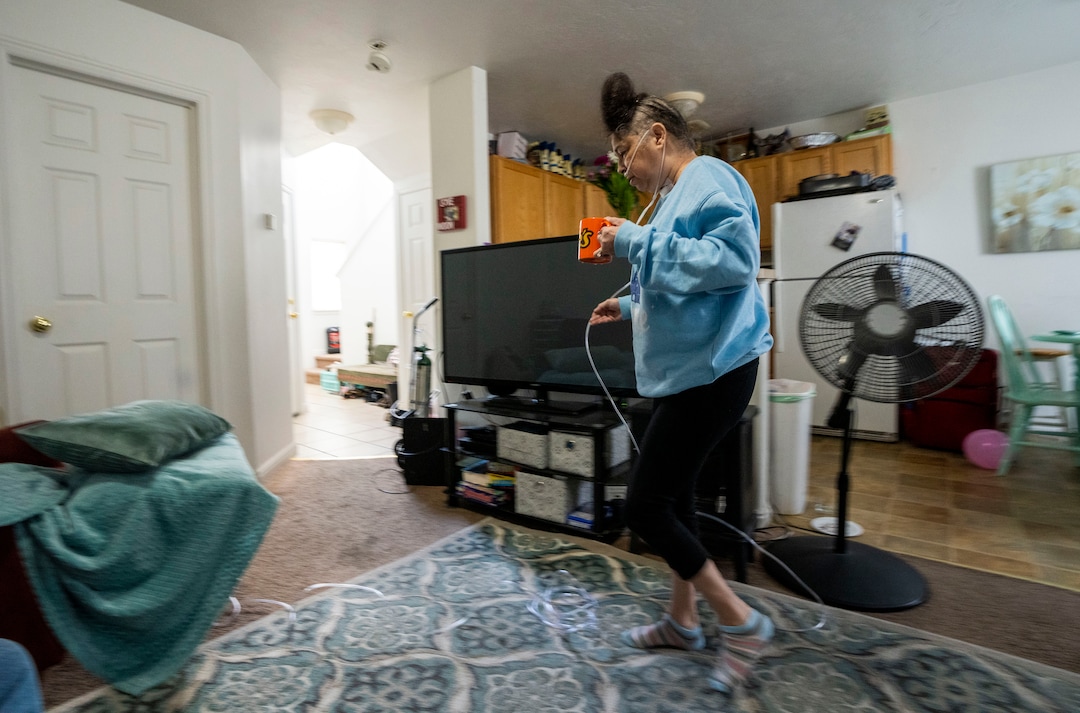 (Rick Egan | The Salt Lake Tribune) Tina Lewis walks back to her recliner, after grabbing a glass of water, on her first full day home at Idaho Falls, Idaho, on Thursday, Sept. 23, 2021. Lewis spent most of the past 6 months in hospitals sick with COVID-19.
