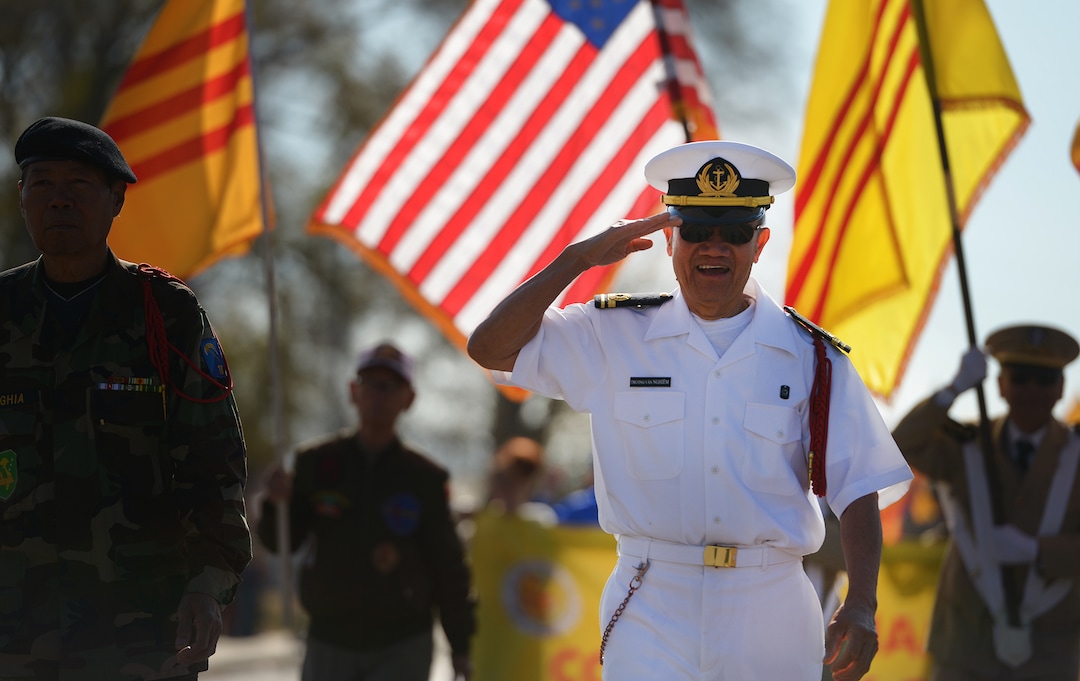 (Leah Hogsten  |  The Salt Lake Tribune)  Vietnam Veteran Truong Van Nghiem, center, marches with fellow members of the Vietnamese Community of Utah represent Vietnam Veterans, political refugee resettlement and immigrants after 1975 during Northern Utah’s 12th Annual Veterans Day Parade Saturday, Nov. 11, 2017 in Layton.