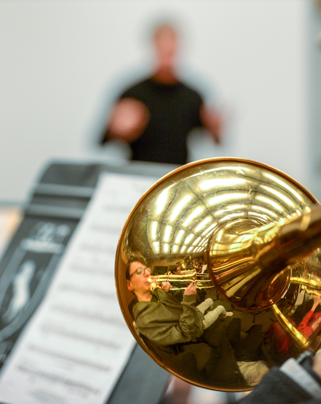 Leah Hogsten  |  The Salt Lake Tribune   Trumbone player Logan Luker is reflected in his bandmate's trumbone during Thursday's practice session with Utah Symphony Music Director Thierry Fischer. Fischer is helping members of the Cottonwood High School symphony bring to life Stravinsky's "The Firebirdâ" through the first Adopt a School pilot program. They will culminate in the performance of the piece on May 20, with Maestro Fischer conducting the live streamed event to other participating Utah orchestras who will be following along as the state's largest "Super Orchestra."