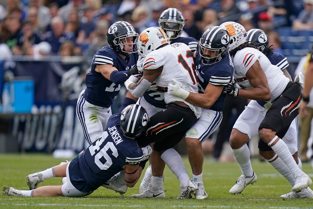 (Rick Bowmer | The Associated Press) Idaho State's Tyevin Ford (12) is tackled by BYU in the first half during an NCAA college football game Saturday, Nov. 6, 2021, in Provo, Utah.