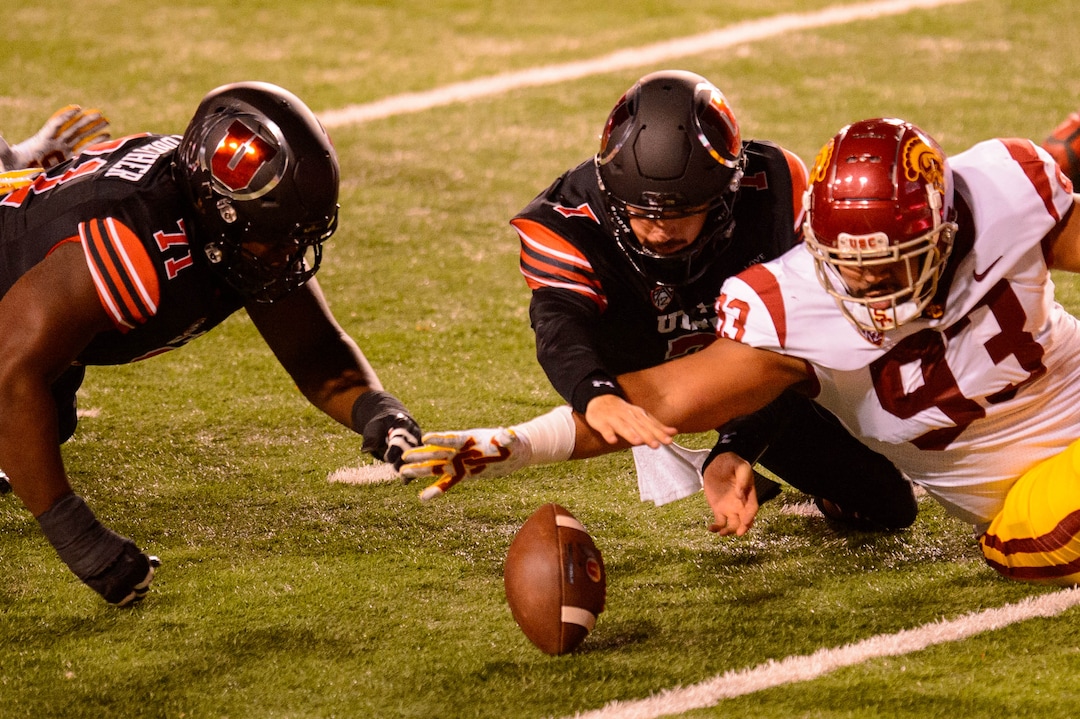 (Trent Nelson  |  The Salt Lake Tribune) Utah Utes quarterback Cameron Rising (7) tries to recover the ball he fumbled as he's hit by USC Trojans defensive lineman Marlon Tuipulotu (93), as the Utah Utes host the USC Trojans, NCAA football at Rice-Eccles Stadium in Salt Lake City on Saturday, Nov. 21, 2020.