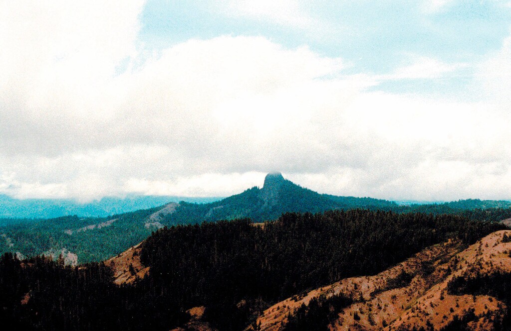 (Jeff Barnard | The Associated Press) In this July 6, 2000, file photo, Pilot Rock rises into the clouds in the Cascade-Siskiyou National Monument near Lincoln, Ore. Contrary to President Donald Trump's numerous efforts to shred Obama's legacy, U.S. Justice Department lawyers are in Obama's corner as they defend his expansion of the national monument in Oregon.