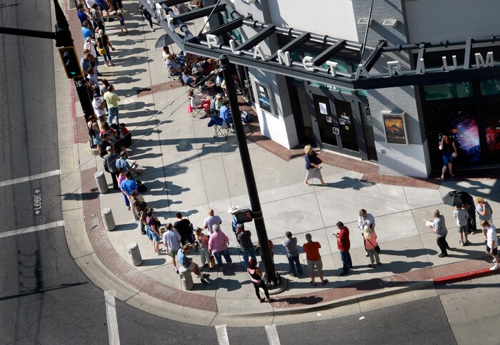 (Scott Sommerdorf | The Salt Lake Tribune) Hundreds of hopeful eclipse-watchers line up in a line that was doubled back upon itself as it stretched around the corner outside the Clark Planetarium. They all were hoping to get eclipse glasses from the gift shop, Thursday, August 17, 2017.