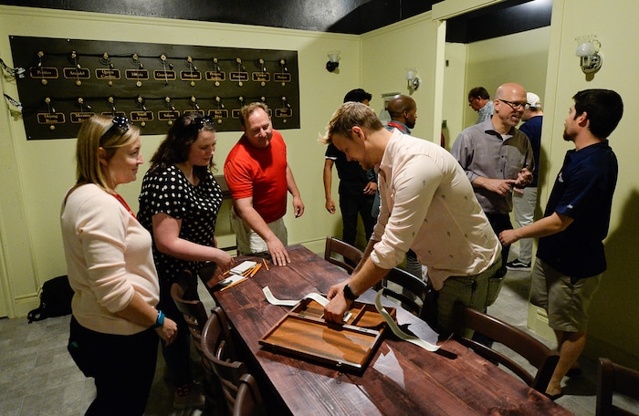 (Francisco Kjolseth  |  The Salt Lake Tribune)  People get a brief preview of the latest attraction at the Mystery Escape Room at The Gateway. They have re-created rooms from "Downton Abbey," where people try to find Mrs. O'Brien's diary before the time is up.