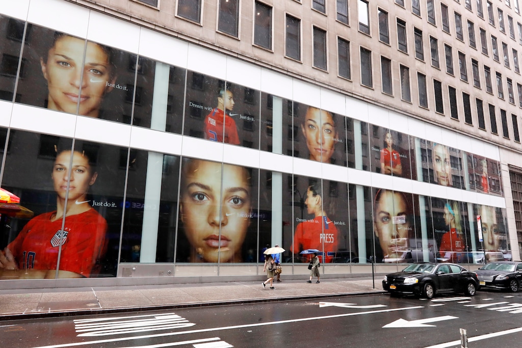 (Richard Drew | AP) Portraits of the USA women's soccer team members are visible in the windows of a building on Fifth Avenue, in New York, Thursday, June 13, 2019. Women's soccer engages the U.S. every four years, then disappears for most fans like Brigadoon. In the wake of the Americans' record-setting fourth World Cup title Sunday, July 7, 2019, the hard part remains ahead: the weekly work of boosting the National Women's Soccer League.