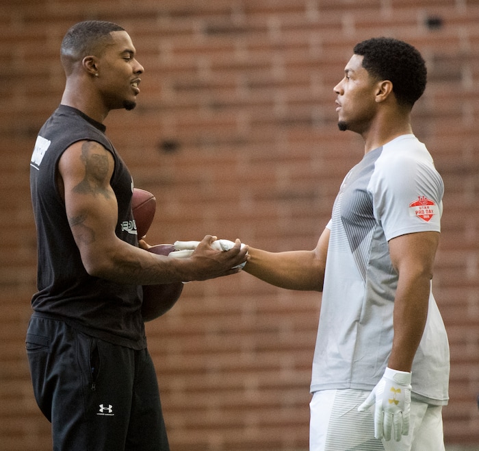 (Rick Egan  |  The Salt Lake Tribune)      Troy Williams shakes hands with Jordan Howard, during University of Utah's 2018 Pro Day for NFL scouts, as Spence Eccles Field House, Wednesday, March 28, 2018.