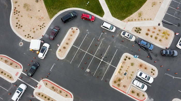 (Leah Hogsten  |  The Salt Lake Tribune) A line of cars bends around the University Of Utah Hospital's parking lot as people wait for COVID-19 testing in Farmington, Oct. 23, 2020.