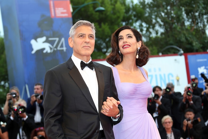 George Clooney, left, and Amal Clooney pose for photographers upon arrival at the premiere of the film 'Suburbicon' during the 74th edition of the Venice Film Festival in Venice, Italy, Saturday, Sep. 2, 2017. (Photo by Joel Ryan/Invision/AP)