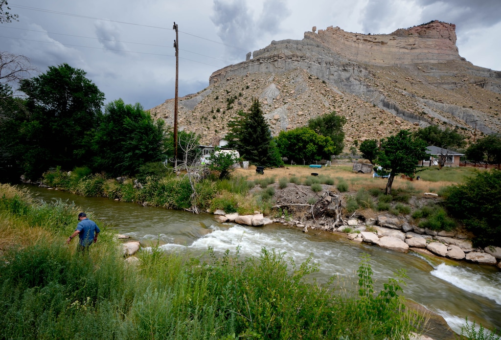 (Francisco Kjolseth | The Salt Lake Tribune) Balance Rock is perched high above the Price River in Helper Utah as Jordan Nielson, Utah Water and Habitat Program Director for Trout Unlimited, visits one of the many phases of the river restoration project on Wednesday, Aug. 16, 2023.