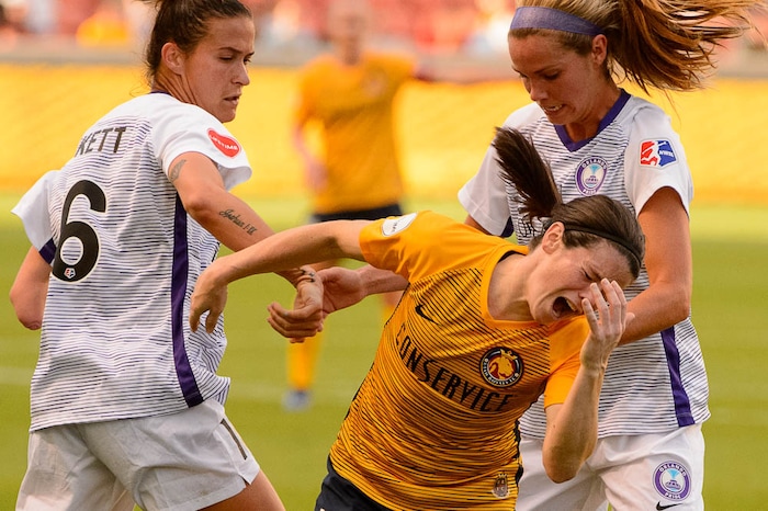 (Trent Nelson | The Salt Lake Tribune)  Utah Royals host Orlando Pride at Rio Tinto Stadium in Sandy, Wednesday May 9, 2018. Utah Royals FC midfielder Diana Matheson (10) reacts to a collision with Orlando Pride defender Carson Pickett (16) and Orlando Pride forward Marta (10).