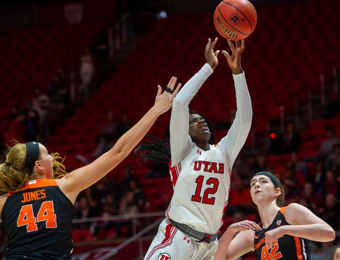 (Rick Egan  |  The Salt Lake Tribune)     Utah Utes forward Lola Pendande (12) shoots as Oregon State Beavers forward Taylor Jones (44)  and forward Kennedy Brown (42) defend, in PAC-12 basketball action between the Utah Utes and the Oregon State Beavers at the Jon M. Huntsman Center, Saturday, Feb. 1, 2020.