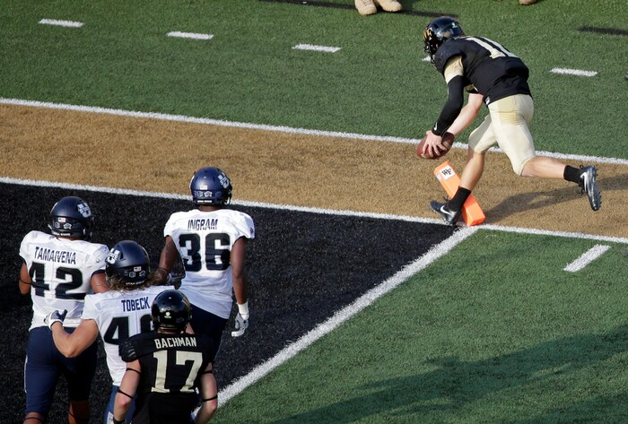 Wake Forest's John Wolford (10) runs for a touchdown against Utah State in the second half of an NCAA college football game in Winston-Salem, N.C., Saturday, Sept. 16, 2017. (AP Photo/Chuck Burton)