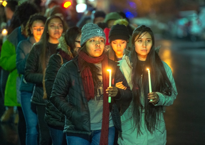 (Rick Egan  |  The Salt Lake Tribune)       Erin Tapahe and Meeya Apelu, lead a procession up the hill, to the top entrance of the Tanner building, during a candlelight vigil on BYU campus, for the student who died by suicide this week, Friday, Dec. 7, 2018.
  
