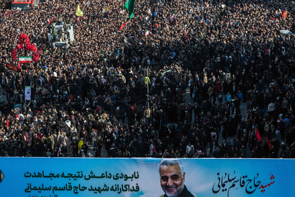 (Arash Khamooshi | The New York Times) A banner bearing the likeness of Maj. Gen. Qassem Suleimani is carried during a funeral procession in Tehran on Monday, Jan. 6, 2019. Suleimani was killed by the United States on Friday in Baghdad in a drone strike.