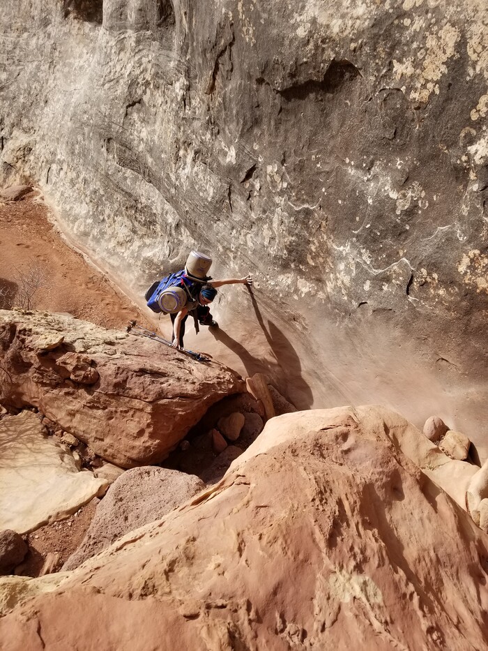 (Nathan Richman | The New York Times) In a photo by Nathan Richman, Kat Vollinger carries measuring instruments into an arch in Canyonlands National Park, Utah. A geologist and his team at the University of Utah have been monitoring with audio recordings, hoping to learn about the structural health of Utah's arches, bridges and towers.