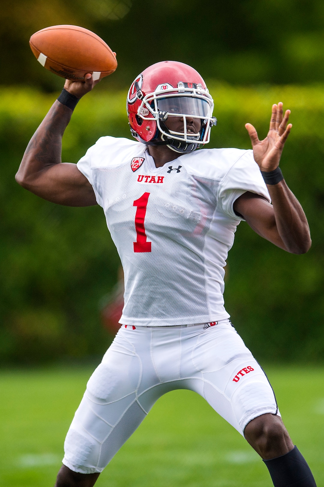 (Chris Detrick  |  The Salt Lake Tribune) Utah Utes quarterback Tyler Huntley (1) throws the ball during practice Tuesday, August 22, 2017. 