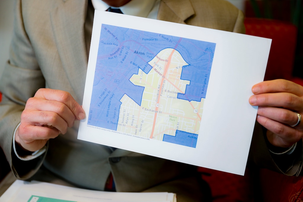 David Niven, a professor of political science at the University of Cincinnati holds a map demonstrating a gerrymandered Ohio district, Thursday, April 11, 2019, in Cincinnati. Congressional Democrats nationwide had a good year in 2018, gaining 40 seats. But Republicans held fast with 75% of Ohio’s House seats, despite winning only 52% of Ohio’s congressional vote total. “Not a single seat has changed hands,” said Niven, who testified for those challenging Ohio’s map. “Not a single seat. The point of this map was to build a seawall against the storm, and it has held.” (AP Photo/John Minchillo)