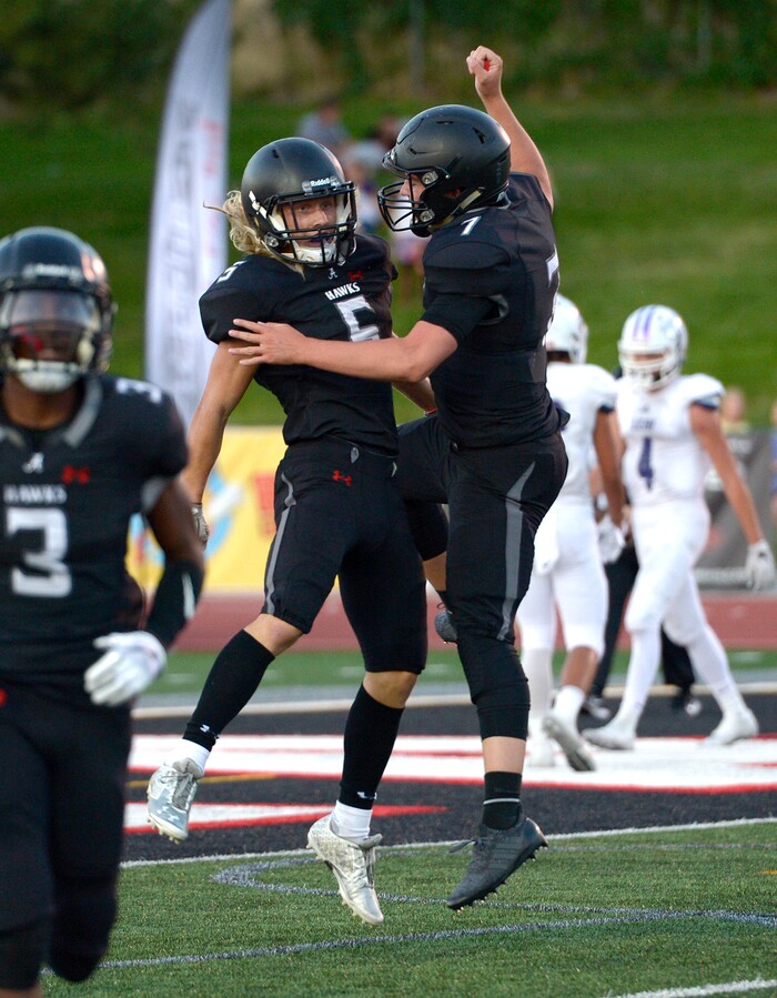 (Leah Hogsten  |  The Salt Lake Tribune) Alta's London Rockwood celebrates his touchdown with Will Dana. Rockwood had two touchdowns. Lehi High School and Alta High School are tied, 42-42 in the second half during their game, Friday, August 18, 2017 in Sandy. 