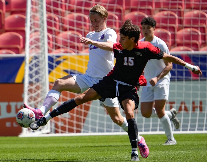 (Francisco Kjolseth | The Salt Lake Tribune) Lehi’s Cole Marriott (22) and Alta’s Faris Kurdi (15) stretch out for the ball during their 5A State Soccer Championship title game at Rio Tinto Stadium, Wednesday, May 25, 2022. Alta defeated Lehi in shootout 3-1.