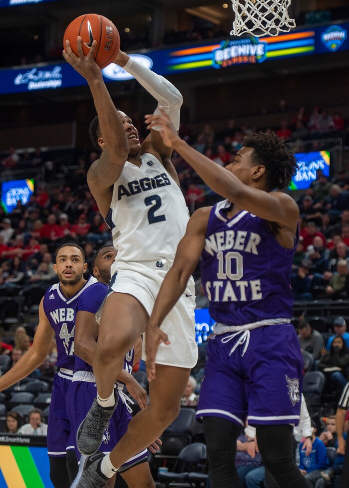 (Rick Egan  |  The Salt Lake Tribune)   Utah State Aggies forward Dwayne Brown Jr. (2) takes the ball to the basket, as Weber State Wildcats guard Jerrick Harding (10)  defends, in the Beehive Classic, between against the Utah State Aggies and Weber State Wildcats, a the Vivint Smart Home Arena, Saturday December 8, 2018.

 