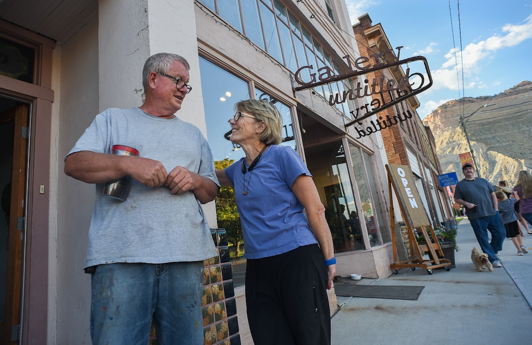 (Francisco Kjolseth  |  The Salt Lake Tribune)  Artists Dave Dornan is joined his wife Marilou Kundmueller, a former nurse from Salt Lake City as they talk about their history in the town of Helper Utah during a recent gallery stroll on the first Friday of every month. The former University of Utah art professor opened an art school in Helper and some of his students bought studios along Main Street.