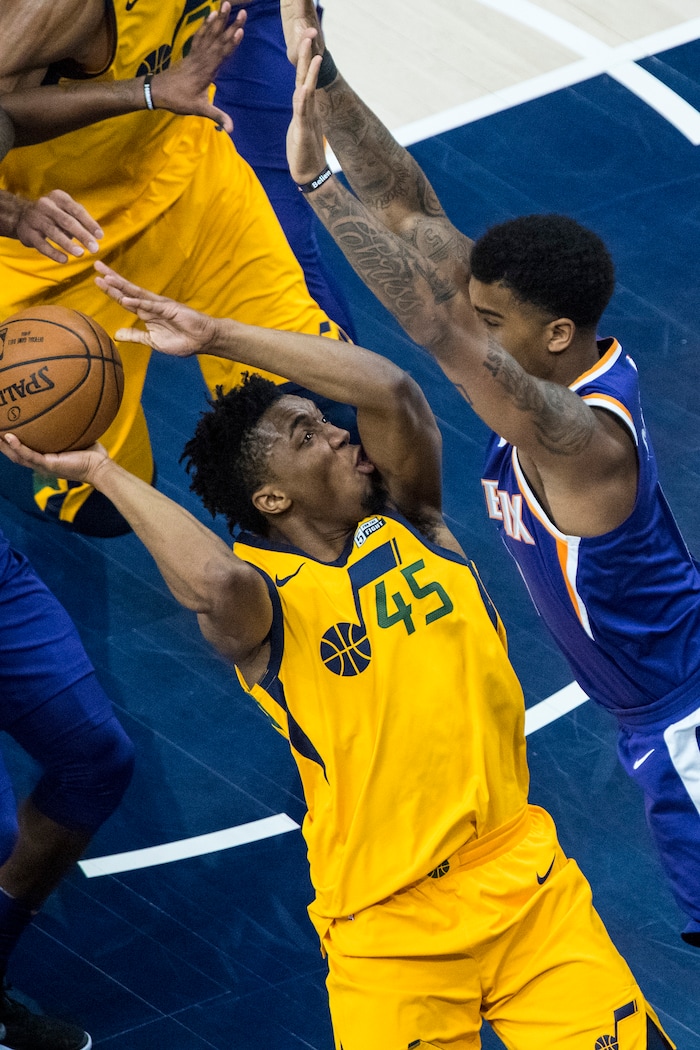 (Chris Detrick  |  The Salt Lake Tribune)  Phoenix Suns forward Marquese Chriss (0) guards Utah Jazz guard Donovan Mitchell (45) during the game at Vivint Smart Home Arena Thursday, March 15, 2018. 