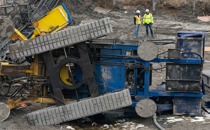 (Francisco Kjolseth | The Salt Lake Tribune) Crews survey the damage of a collapsed drill rig as seen on Wednesday, March 16, 2022, at the intersection of State Street and 200 South. The rig toppled over Tuesday night at the site of the new Astra Tower, crushing two unoccupied parked cars and sending the crane operator to the hospital in serious condition.