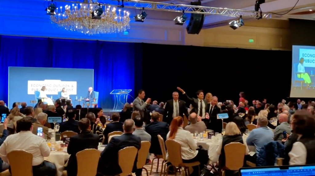 (Paighten Harkins | The Salt Lake Tribune) A heckler is escorted out of a ballroom at the Grand America Hotel in Salt Lake City after interrupting former U.S. Sen. Kyrsten Sinema on Friday, Jan. 16, 2026.