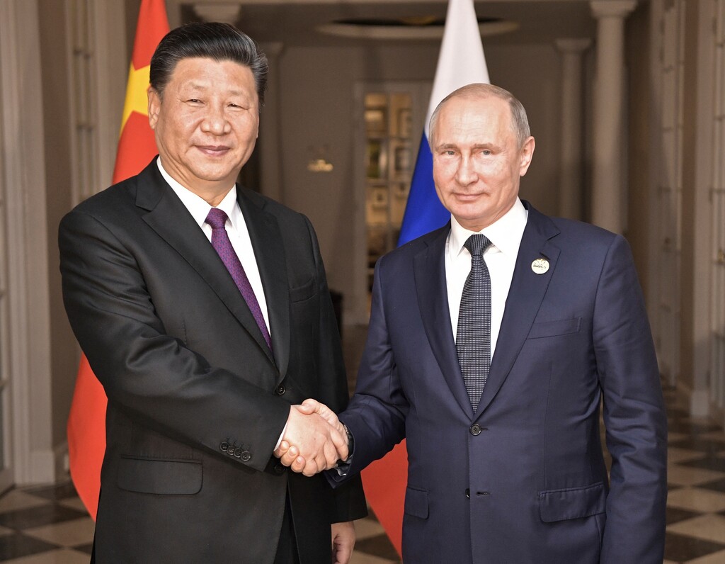 (Alexei Nikolsky | Sputnik | Kremlin Pool Photo | The Associated Press) China's President Xi Jinping, left, poses with Russia's President Vladimir Putin for a photo at the BRICS summit in Johannesburg, South Africa, Thursday, July 26, 2018. Xi said Wednesday the world faces "a choice between cooperation and confrontation."