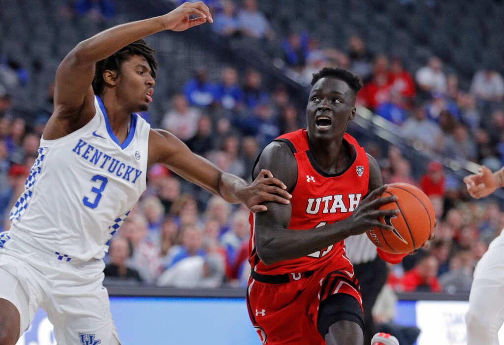 Utah's Both Gach (11) drives around Kentucky's Tyrese Maxey (3) during the first half of an NCAA college basketball game Wednesday, Dec. 18, 2019, in Las Vegas. (AP Photo/John Locher)