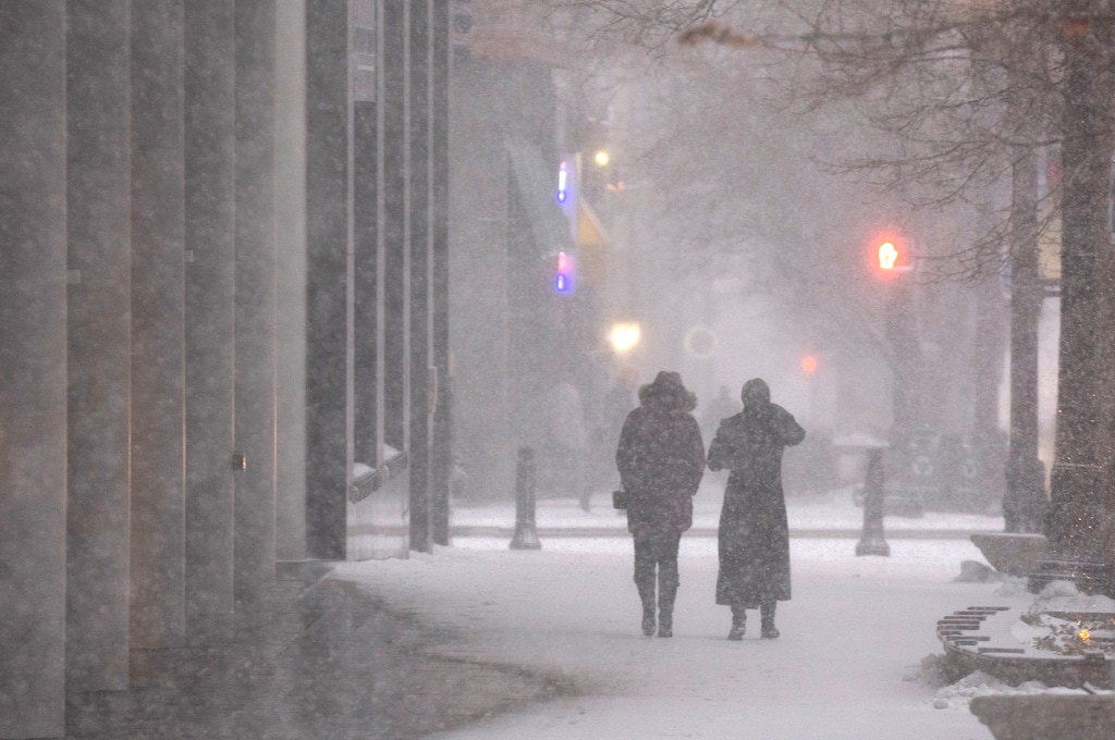 (Rick Egan | The Salt Lake Tribune)   Pedestrians walk down Main Street during a snow squall on Wednesday, Jan. 10, 2024. After a bit of "false spring," snow is headed back to Utah.