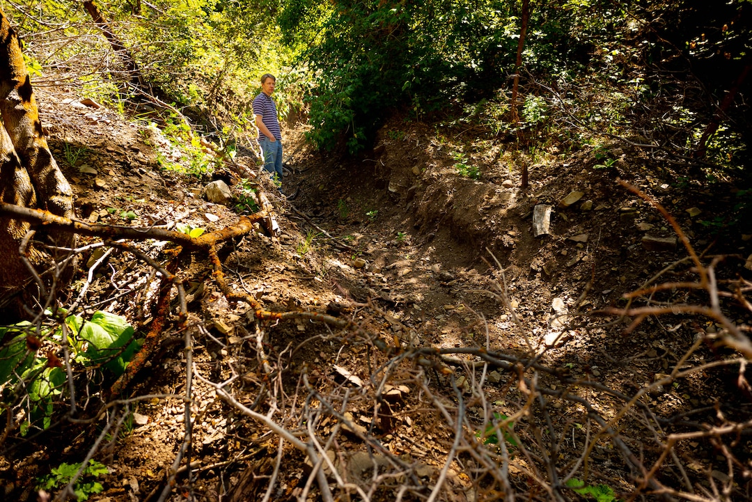 (Trent Nelson  |  The Salt Lake Tribune)  Kirk Richards stands in a diversion ditch near his Woodland Hills home on Thursday Aug. 15, 2019.