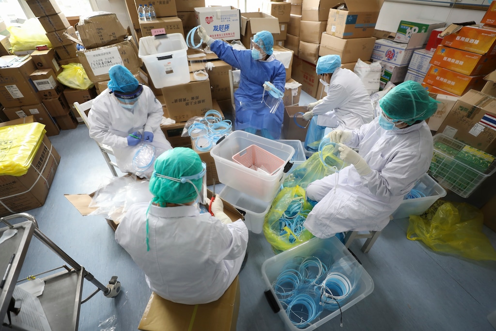 (Chinatopix via AP) Nurses assemble plastic face shields at a hospital designated for the coronavirus patients in Wuhan in central China's Hubei province, Sunday, March 01, 2020. China on Sunday reported a slight uptick in new cases exceeded 500 over the past 24 hours. They remain almost entirely confined to the hardest-hit province of Hubei and its capital, the epicenter of Wuhan.