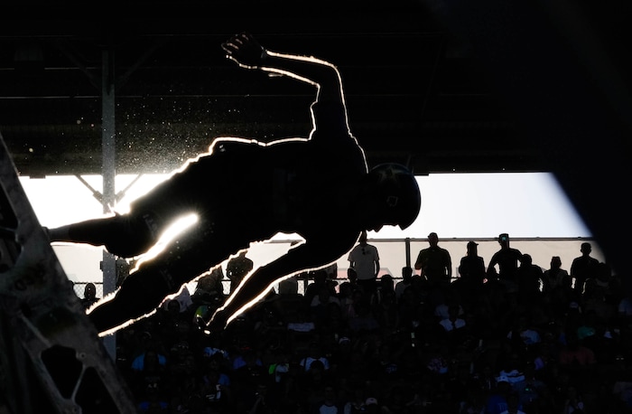 (Francisco Kjolseth | The Salt Lake Tribune) Skaters are silhouetted in the late evening sun during Tony Hawk’s Vert Alert, a big-air skateboarding competition at the Utah Sate Fairpark on Friday, Aug. 26, 2022. 