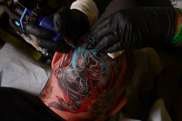 (Leah Hogsten | The Salt Lake Tribune) Herb Auerbach, a tattoo artist with California Electric colors a head tattoo at the Salt Lake City International Tattoo Convention Saturday, March 17, 2018.