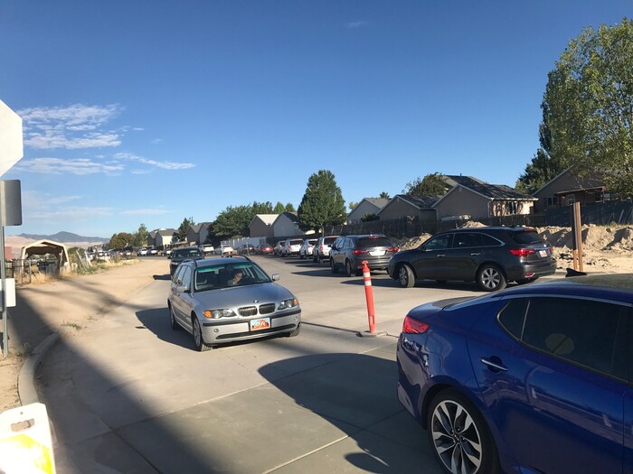 (Benjamin Wood | The Salt Lake Tribune)   Faculty members with American Preparatory Academy in Draper helped direct traffic as families arrived Monday for the first day of the 2017-2018 school year.