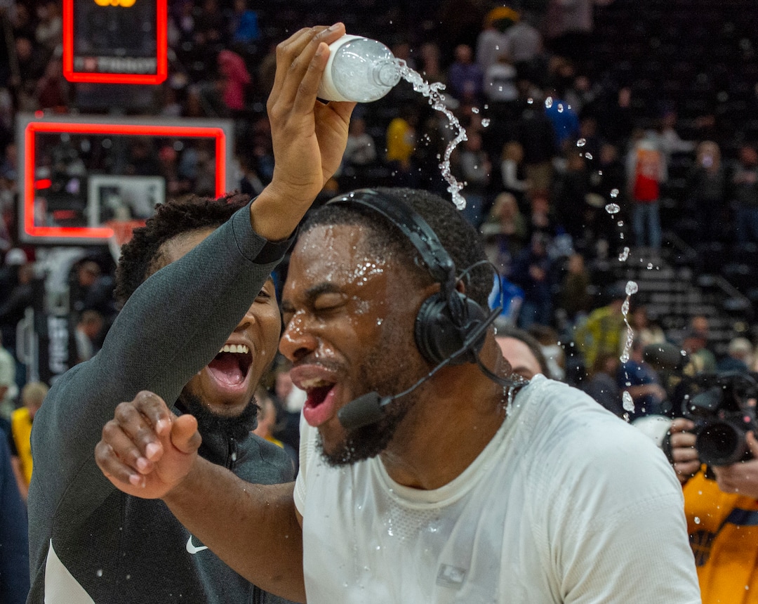 (Rick Egan  |  The Salt Lake Tribune) Utah Jazz guard Donovan Mitchell (45) pours water on Utah Jazz guard Emmanuel Mudiay (8) during a post game interview after the Utah Jazz defeated the New York Knicks 128-104, in NBA action in Salt Lake City, Wednesday, Jan. 8, 2020.