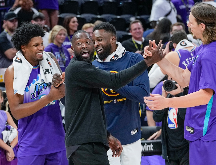 (Leah Hogsten | The Salt Lake Tribune) The Jazz, Utah Jazz forward Rudy Gay (22), part owner Dwyane Wade, Denver Nuggets forward Jeff Green (32) and Utah Jazz forward Kelly Olynyk (41) celebrate the win as the Utah Jazz defeat the Denver Nuggets 123-102 during the team's home and season opener at Vivint Arena, Oct. 19, 2022.