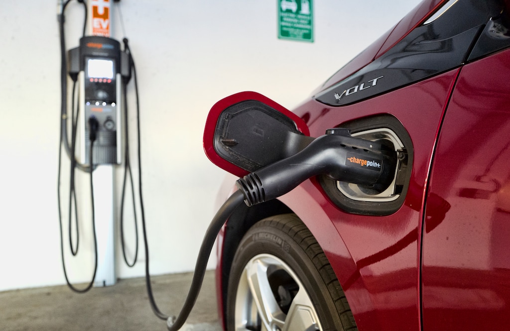 (Richard Vogel | AP file photo) A Chevrolet Volt hybrid car charges at a ChargePoint charging station at a parking garage in Los Angeles on Oct. 17, 2018.