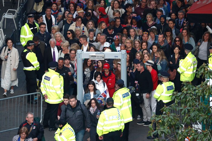 Members of the public pass a security screening as they arrive on castle hill ahead of the wedding ceremony of Prince Harry and Meghan Markle at St. George's Chapel in Windsor Castle in Windsor, near London, England, Saturday, May 19, 2018. (Odd Andersen/pool photo via AP)