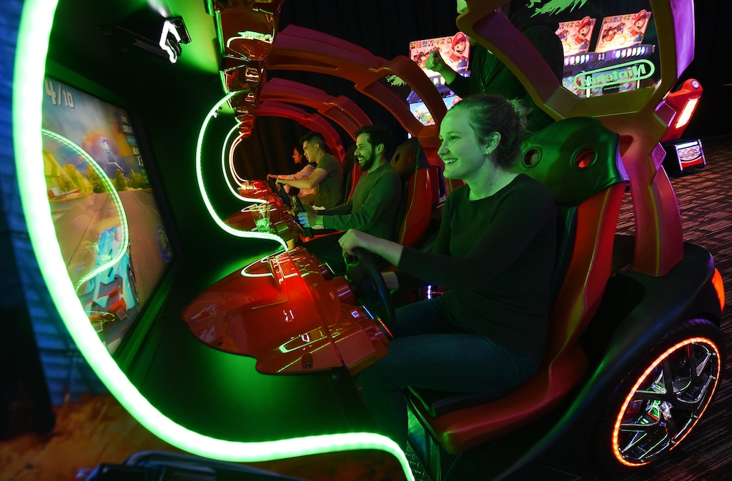 (Francisco Kjolseth | The Salt Lake Tribune) Andie Saunders joins friends as they play the Cruis'n Blast driving game as Dave & Buster's restaurant and entertainment business hosts a VIP event on Thursday, May 10, 2018, at its new Salt Lake City venue at The Gateway before officially opening to the public on Monday, May 14.