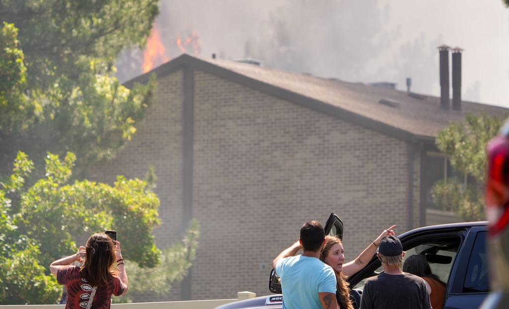 (Chris Samuels | The Salt Lake Tribune) Onlookers observe a fire on 1300 East near Murray-Holladay Road in Millcreek, Friday, July 25, 2025.
