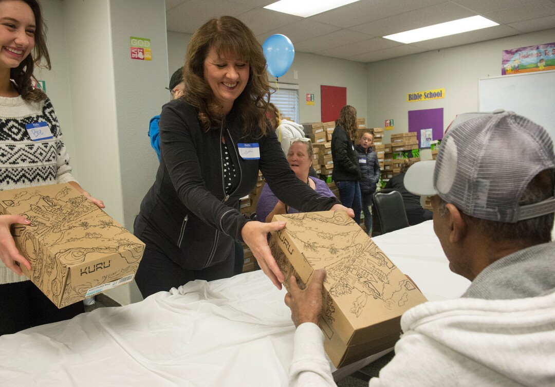(Rick Egan  |  The Salt Lake Tribune)     Volunteers Breanna and Lisa Howlett help distribute shoes at the 25th Annual Thanksgiving Dinner for the hungry and homeless at the Christian Life Center on Redwood Road in Salt Lake City, Wednesday, Nov. 21, 2018.