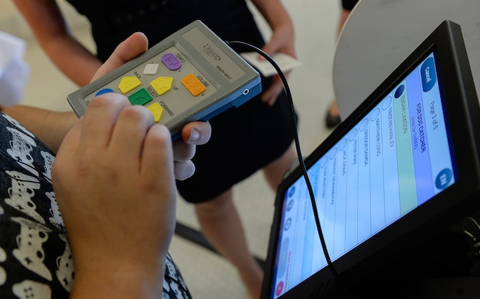 (Francisco Kjolseth  |  The Salt Lake Tribune) A controller with brail buttons to help the visually impaired is one of three ways to navigate a voting machine manufactured by Voting Solutions. Companies demonstrated new voting machines that the state is considering buying during a hands on presentation at the Capitol on Wednesday, Aug. 2, 2017.