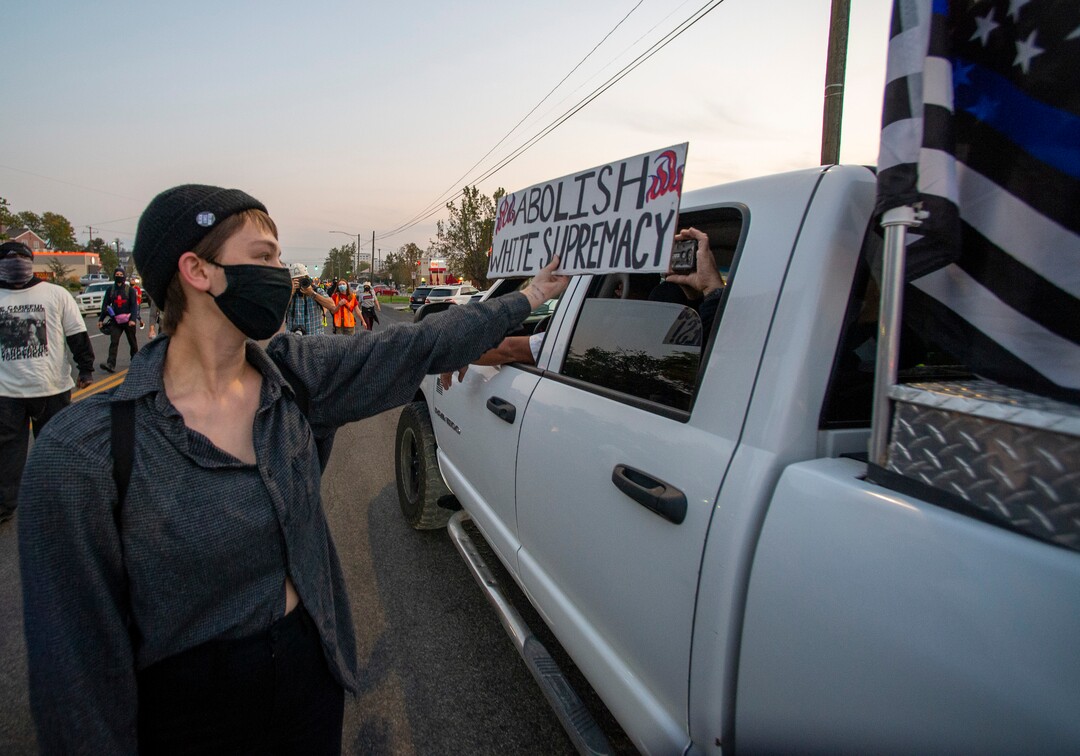 (Rick Egan  |  The Salt Lake Tribune)   A protester blocks a cell phone camera as protesters march near the University of Utah where Vice President Mike Pence is debating Sen. Kamala Harris on Wednesday, Oct. 7, 2020.