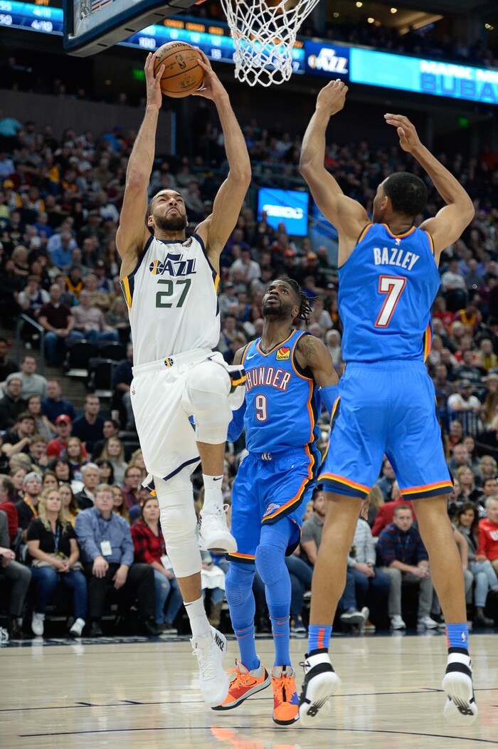 (Francisco Kjolseth  |  The Salt Lake Tribune)  Utah Jazz center Rudy Gobert (27) goes to the basket over Oklahoma City Thunder forward Darius Bazley (7) as the Utah Jazz host the Oklahoma City Thunder in their NBA basketball game at Vivint Smart Home Arena in Salt Lake City on Mon. Dec. 9, 2019.
